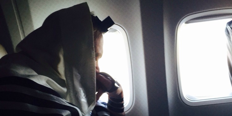 Rabbi Eckstein praying on plane