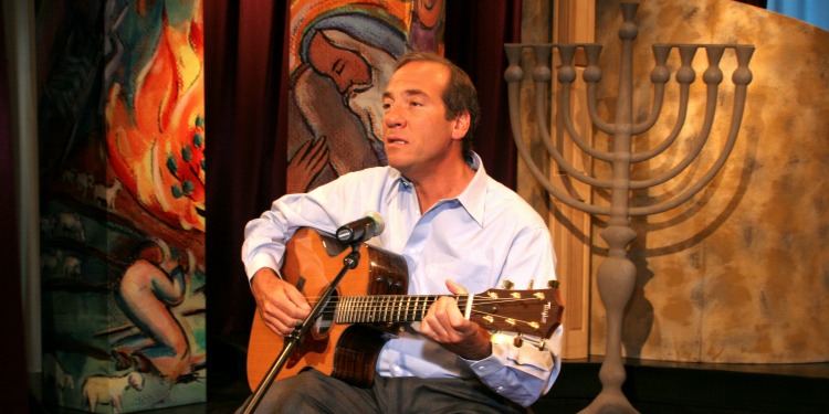 Rabbi Eckstein playing guitar