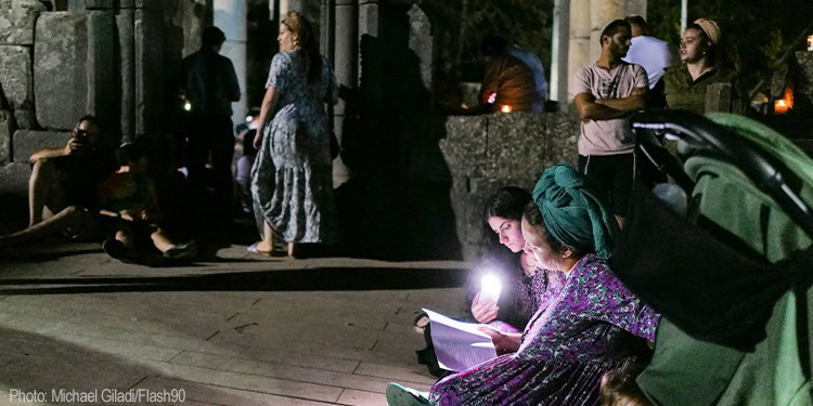 Religious Jews attend the reading of the Book of Lamentation