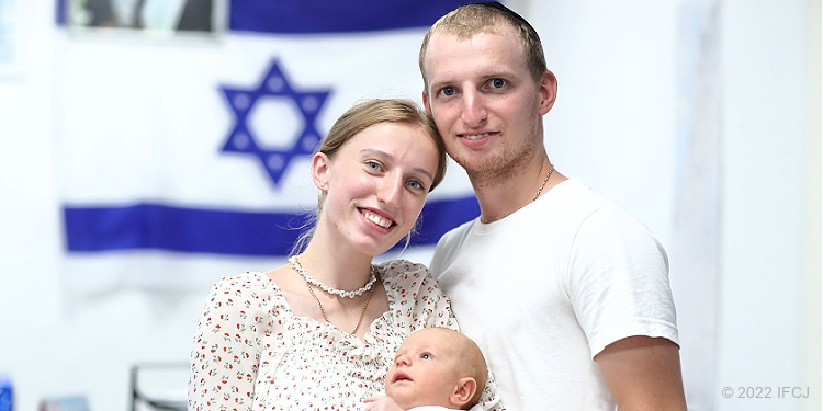 Husband, wife and baby who are Ukrainian refugees who made aliyah to Israel.