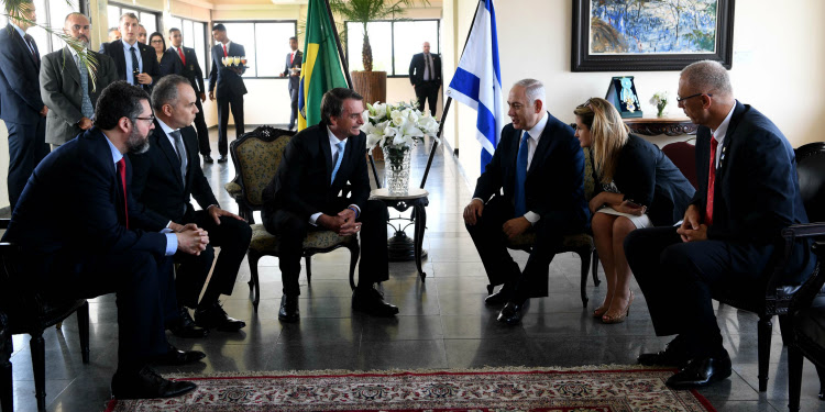 Bibi sitting with five other people having a conversation.