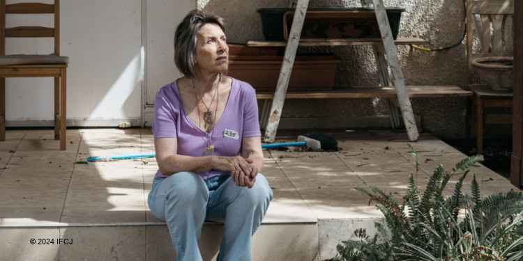 Adele Raemer sitting on a deck looking up
