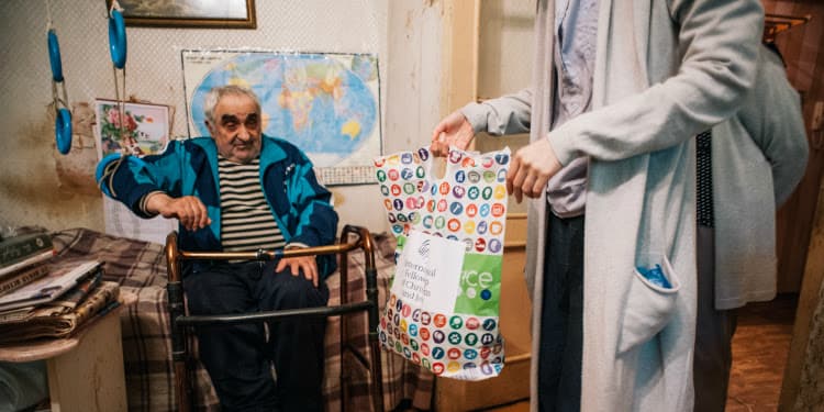 Alexander Orlovsky, an IFCJ recipient receiving a goody bag.