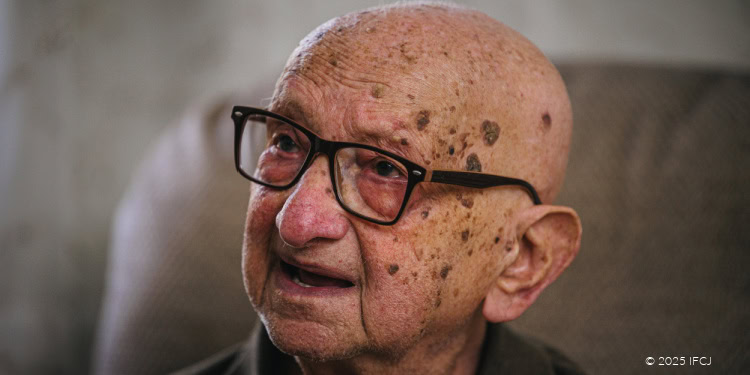 “He Was Like a Grandson to Me,” - joint initiative of the Foundation for the Welfare of Holocaust Victims and IFCJ Asher Volach - elderly man, black framed glasses - tan recliner