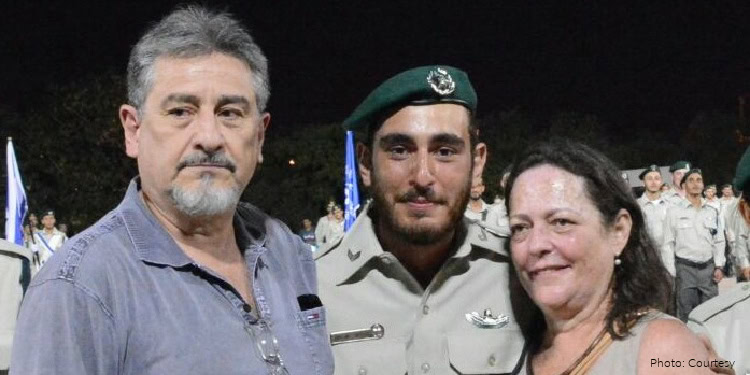 Military family support event organized by IFCJ featuring a soldier with his parents, highlighting compassion and community aid.