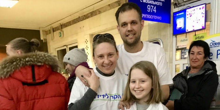The Laskorunskyi Family smiling at the camera in IFCJ shirts.