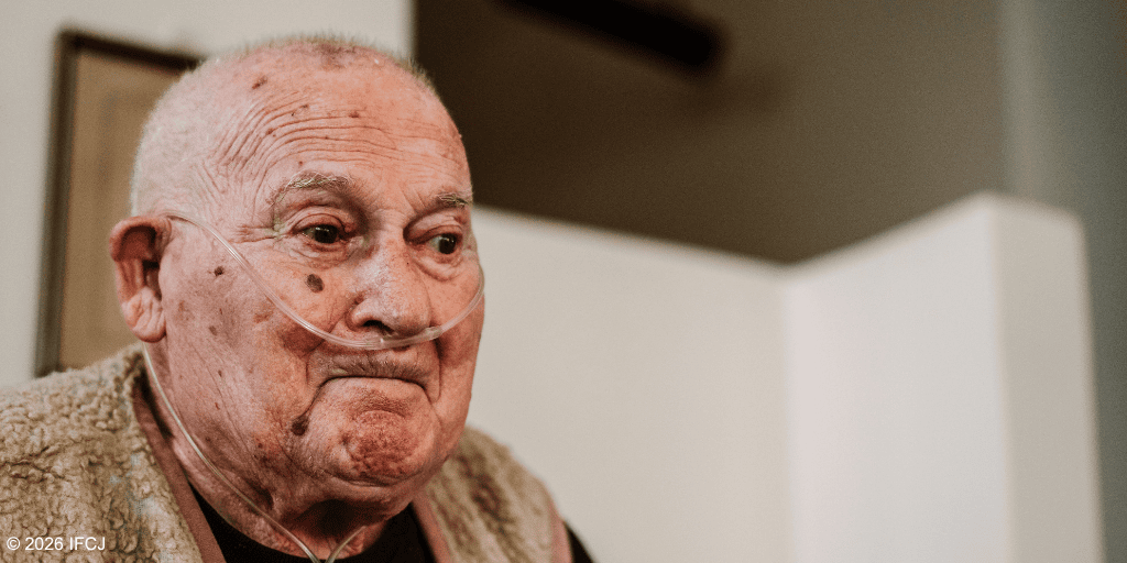 Elderly man with oxygen tube in a care setting, symbolizing compassion and support for seniors.