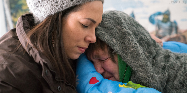 An elderly Jewish woman named Luba prepares for the winter cold thanks to IFCJ donors