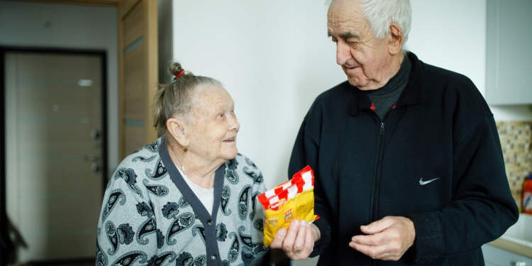 Elderly Jewish couple receiving emergency supplies during war in Ukraine