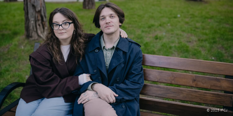 Young couple sitting on a park bench, symbolizing hope and resilience during challenging moments, reflecting the theme "Back Then It Felt Impossible, Just a Dream".