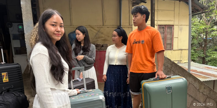 Travelers with luggage at a welcoming location, symbolizing hope and faith.