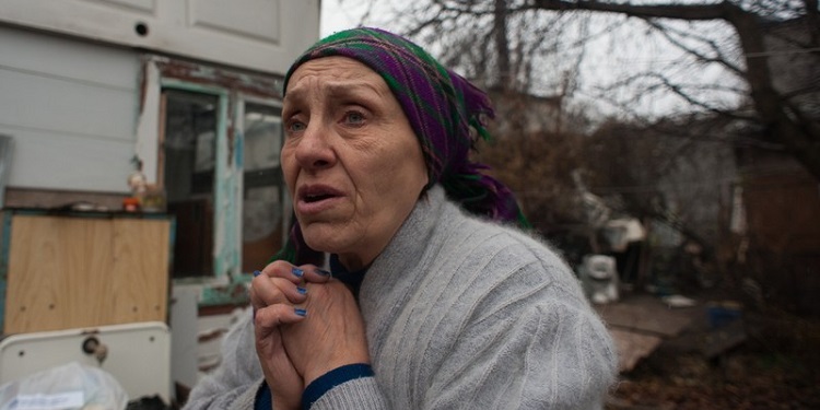 Tatiana Polonetskaya, elderly woman, standing outside in the cold winter.