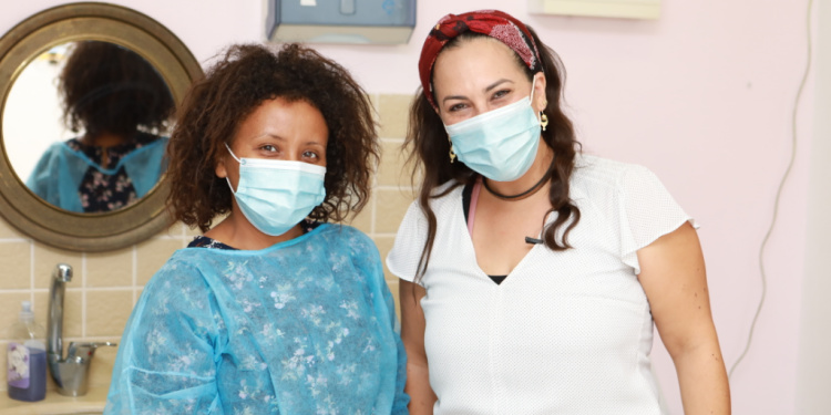 Yael Eckstein and dental student Tazita Abaro standing together looking into the camera.