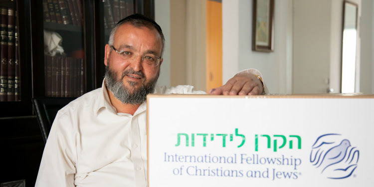 Uriel Shuisha with an IFCJ branded food box.