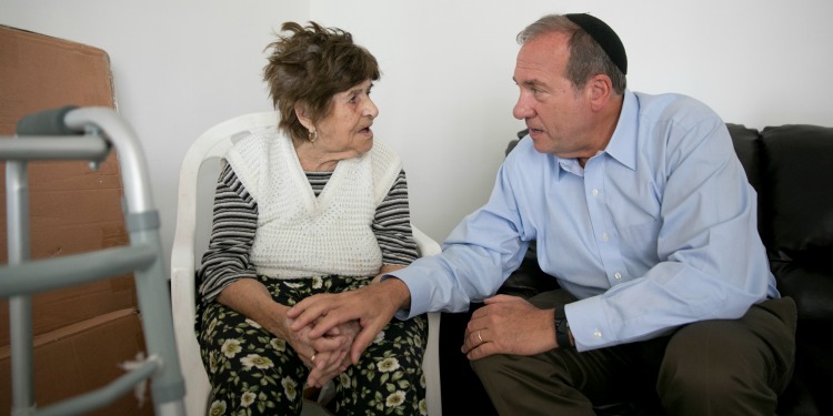 Rabbi Eckstein talking with an elderly Jewish woman.