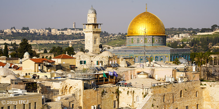 A closer image of the Temple Mount behind a few other buildings.