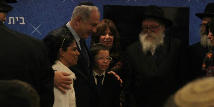 Bibi walking alongside a woman and a young boy.
