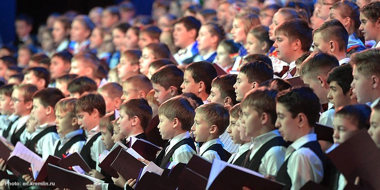 Several children in uniform singing for their choir.