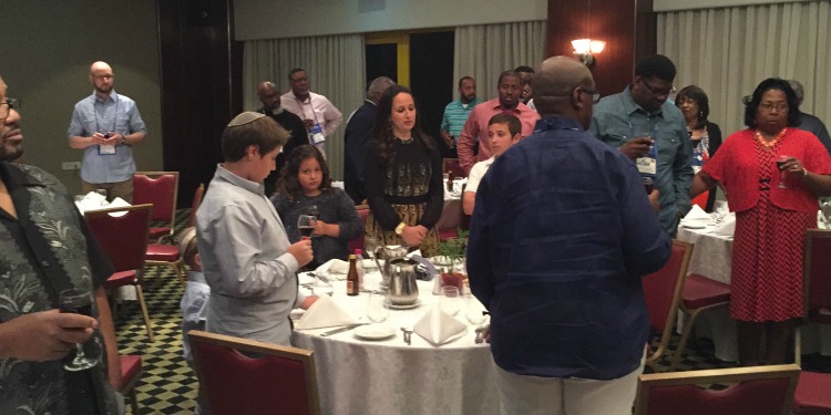 Several people gathered together for Shabbat dinner.