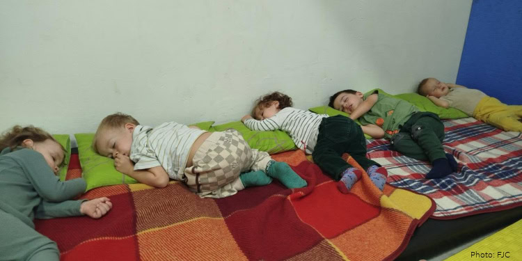 Children from the Simcha Jewish School in Kyiv - in underground bomb shelters during air-raids from Russia. Sleeping, taking naps on makeshift beds.