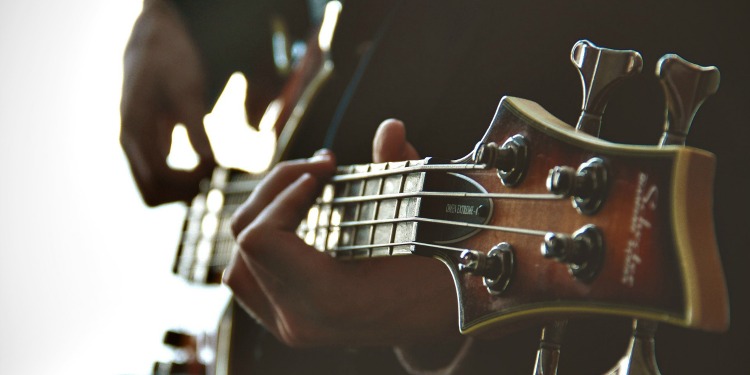 Close up on the fingers of someone playing a guitar.