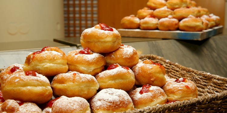 Plate featuring donuts with jam inside them.