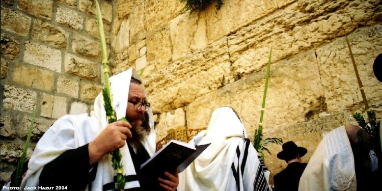 Man praying at the Western Wall during Sukkot.