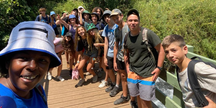 Summer camp in Israel. group of kids standing on bridge, outdoors, group photo, smiling, happy