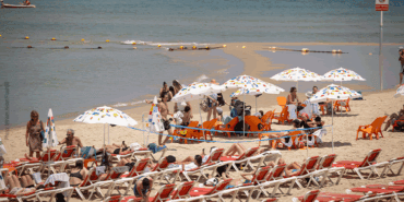 People sitting on a beach in beach chairs