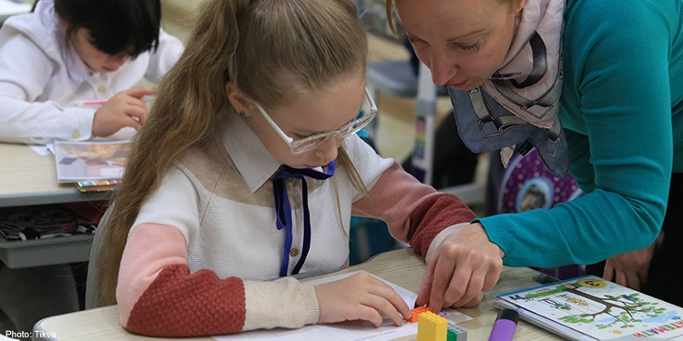 Teacher showing student how to solve a math problem