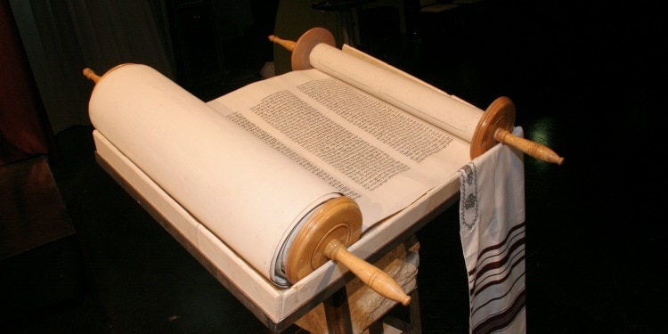 A scroll on a table partially open.