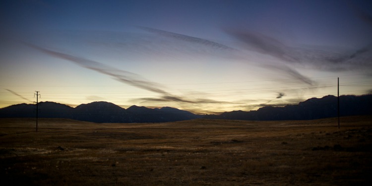 Small mountains in a desert as dawn sets in.