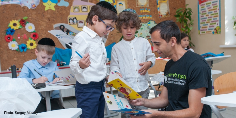 Children interact with Fellowship staff at Tikva Odesa school in Ukraine.