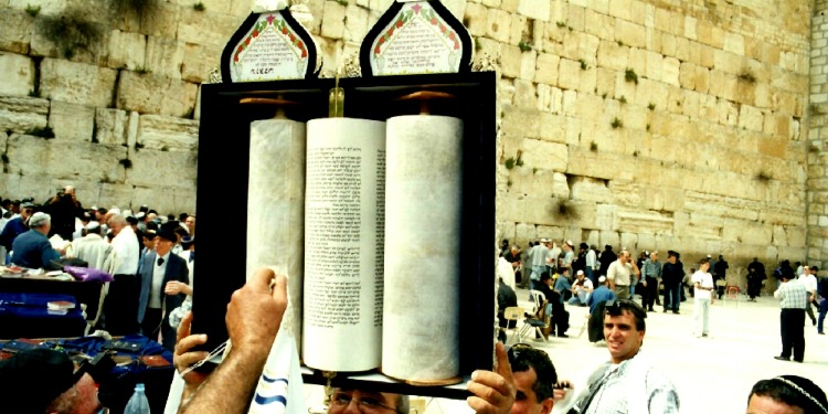 The Torah being held up over everyone at the Western Wall.