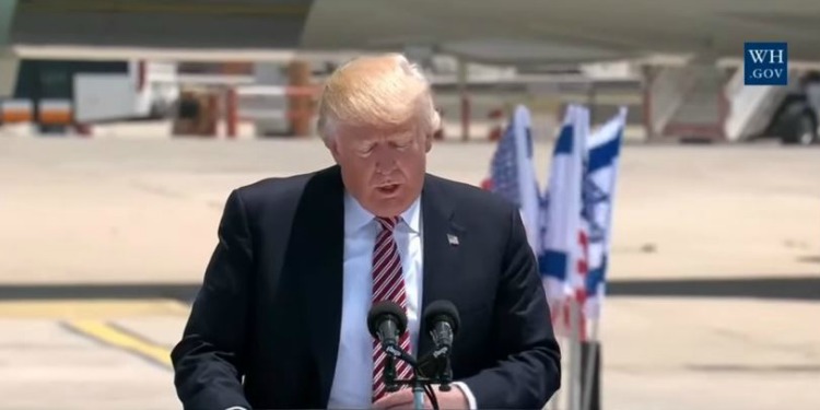 President Trump giving a speech at a podium in Israel.