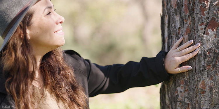 Yael touching a tree