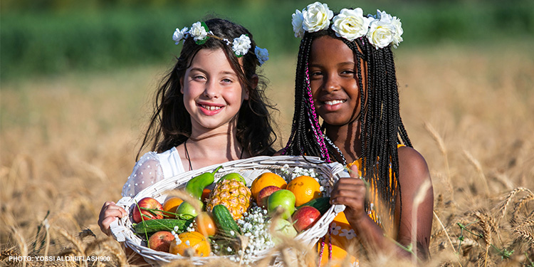 Two girls in the field during Shavuot