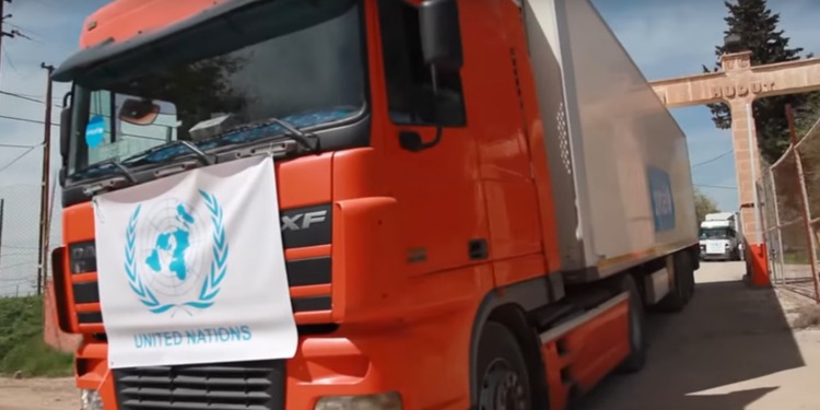 Large truck with the United Nations logo on the front of it.