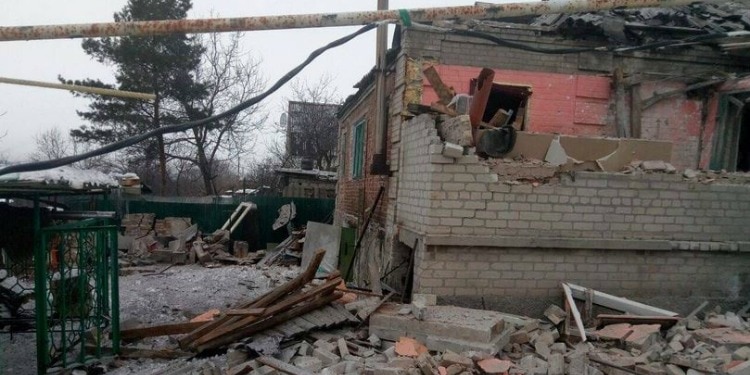 A torn down house with bricks and other debris beside it.