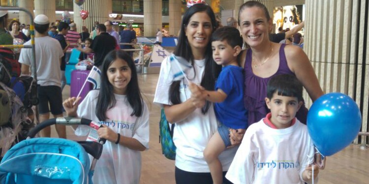 Family in IFCJ shirts who just made Aliyah at the airport.
