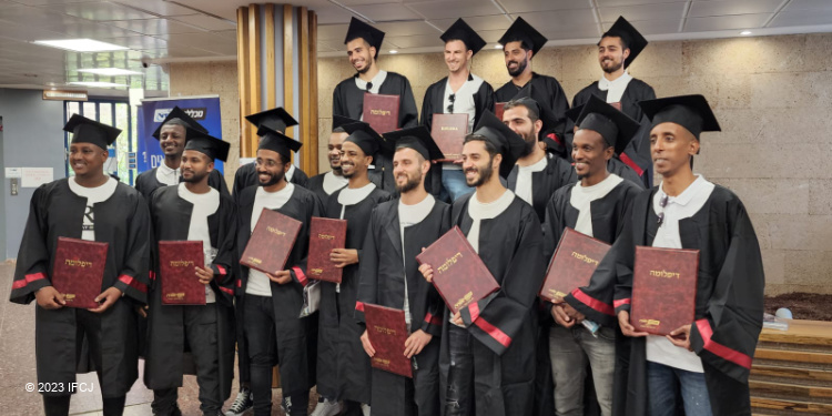 Group of young men at their graduation for ceremony for vocational training for electricians.