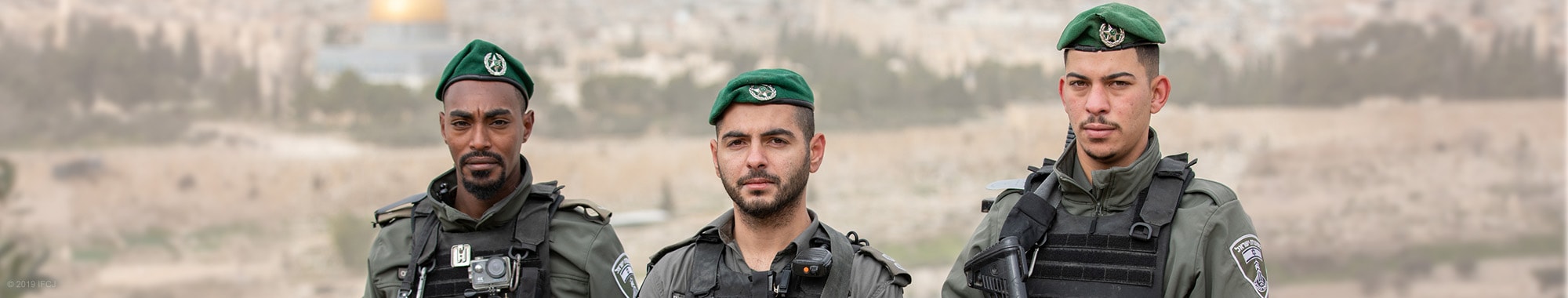 IDF soldiers in their uniforms stand outside of the Old City in Jerusalem