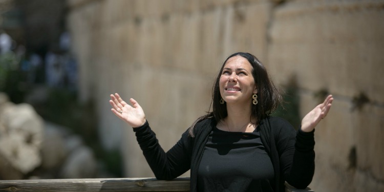 Yael Eckstein smiling with hands up at Western Wall