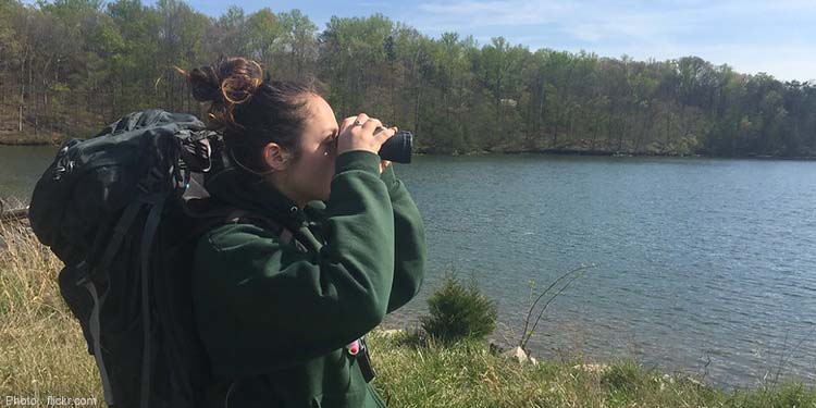 A woman bird-watching holding binoculars