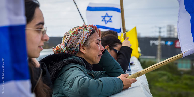 Woman crying holding an Israeli flag