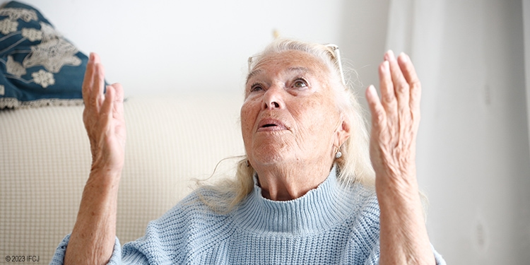 Woman raising hands in the air praising