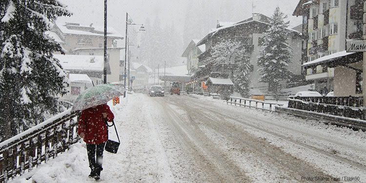 Woman walking with umbrella in the snow