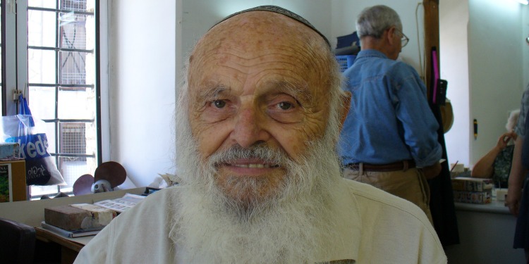 Yad LaKashish an elderly man wearing a kippah while sitting in a room.