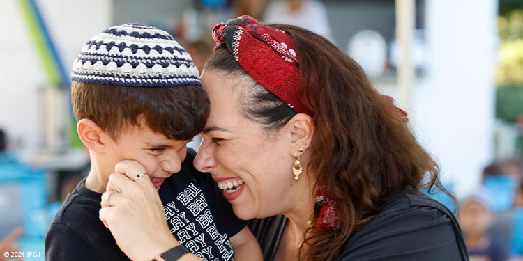 Yael Eckstein hugging young boy