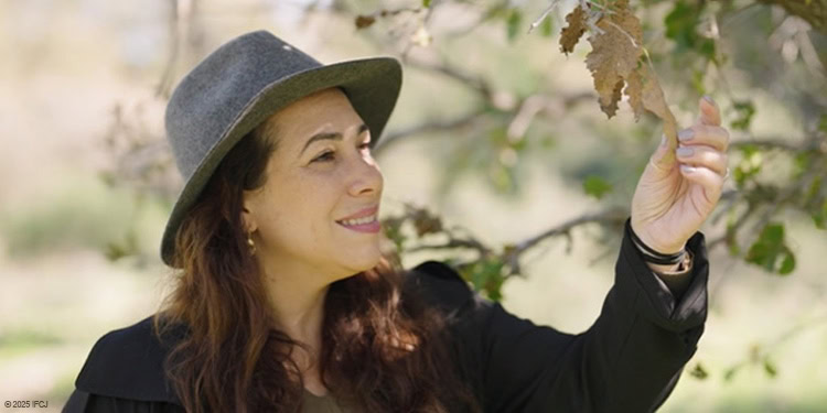Yael Eckstein touching a leaf from a tree